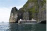 Phi Phi ferry dwarfed by the vertical limestone cliffs of Phi Phi Ley