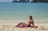 Bikini girl on the beach in Phi Phi Island's busy season
